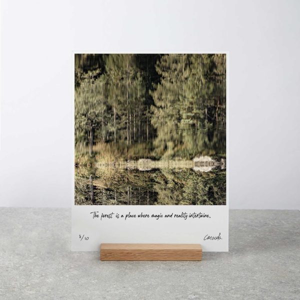 Art board print displayed elegantly on a wooden stand, showcasing the beauty of Norwegian landscapes.